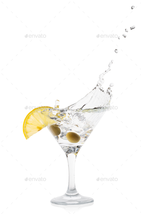Martini splash with lemon and green olives in a transparent cocktail